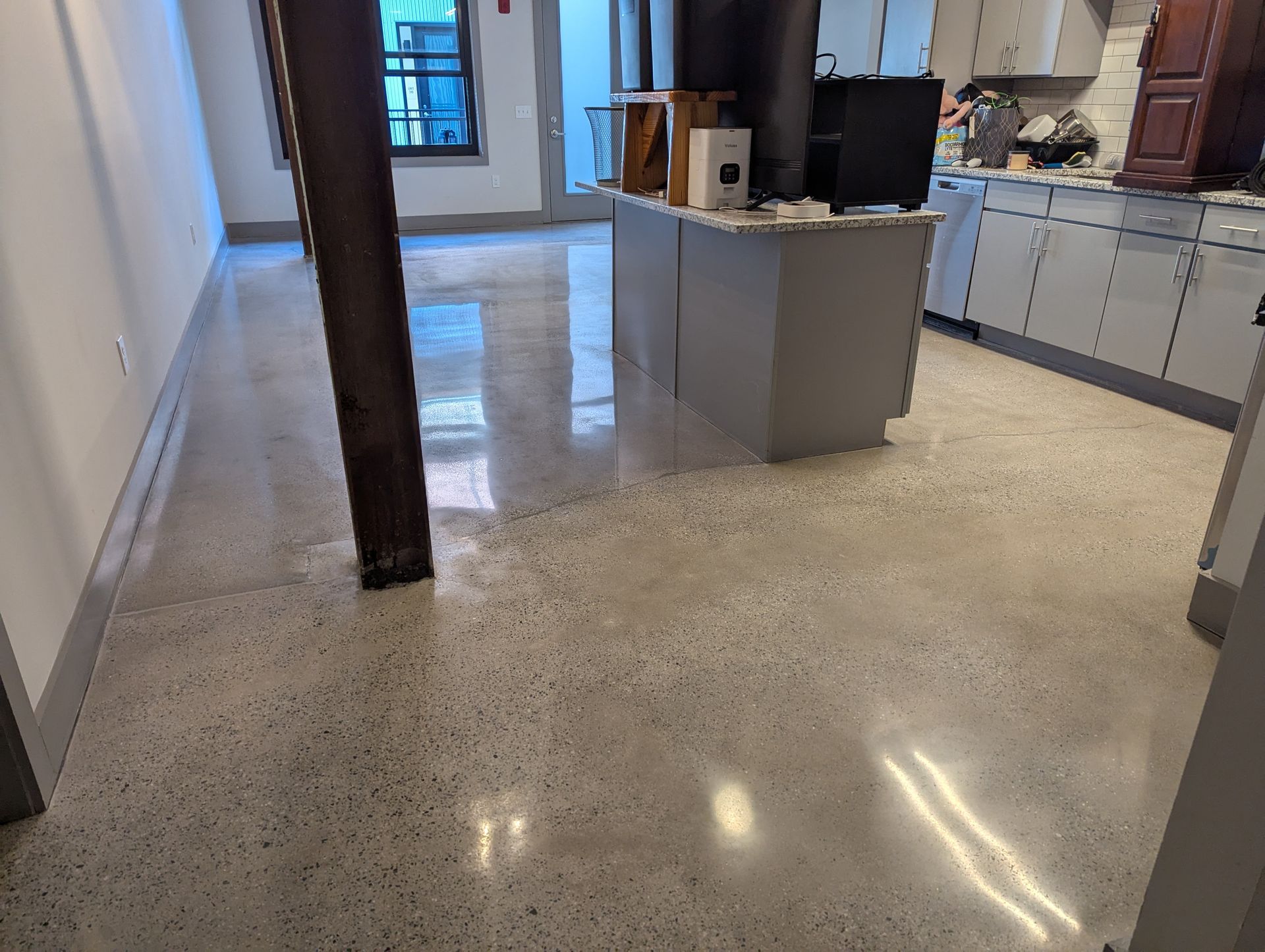 A large room with a shiny floor and a lot of doors.