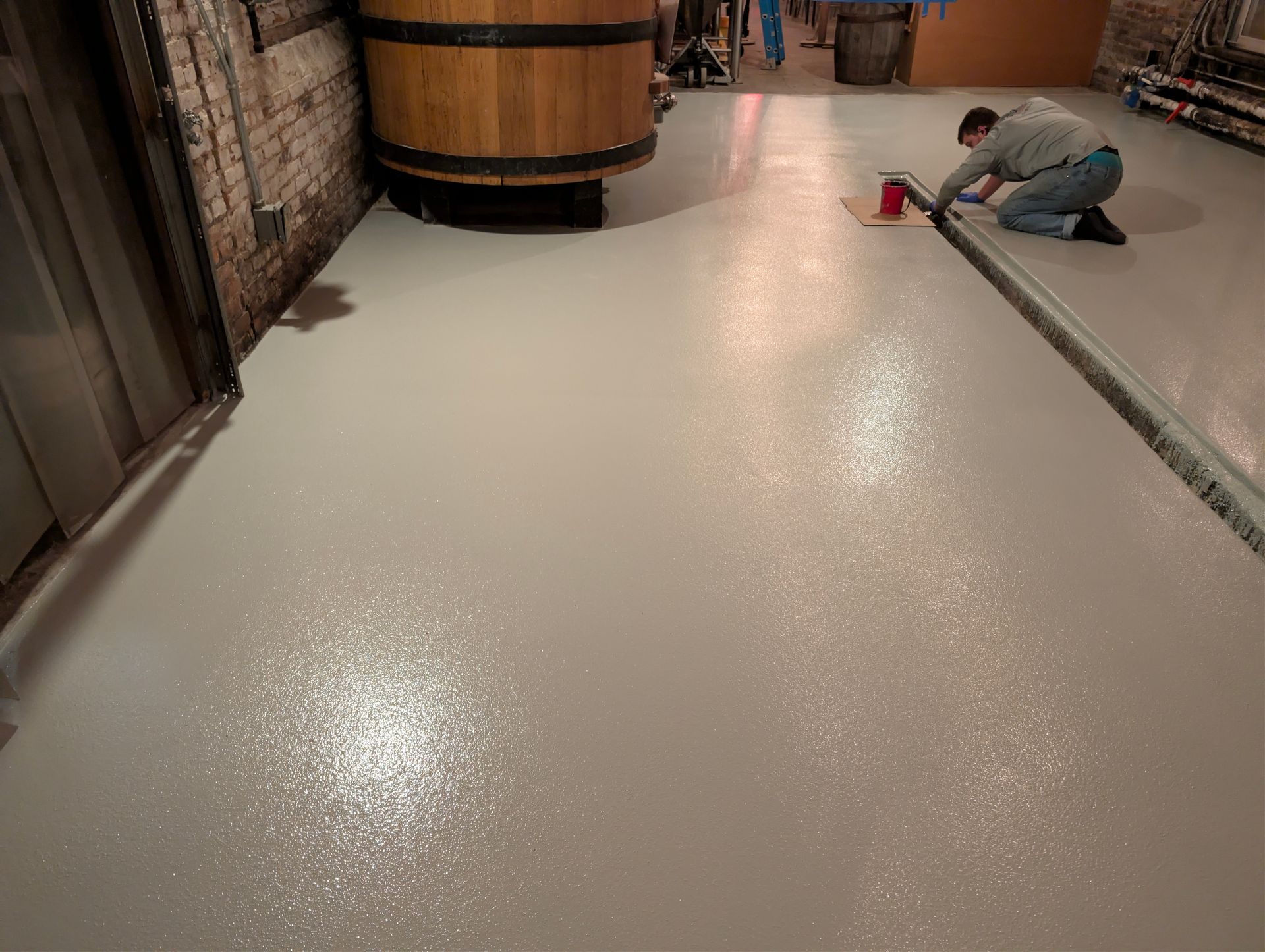 A room with a concrete floor and a window.