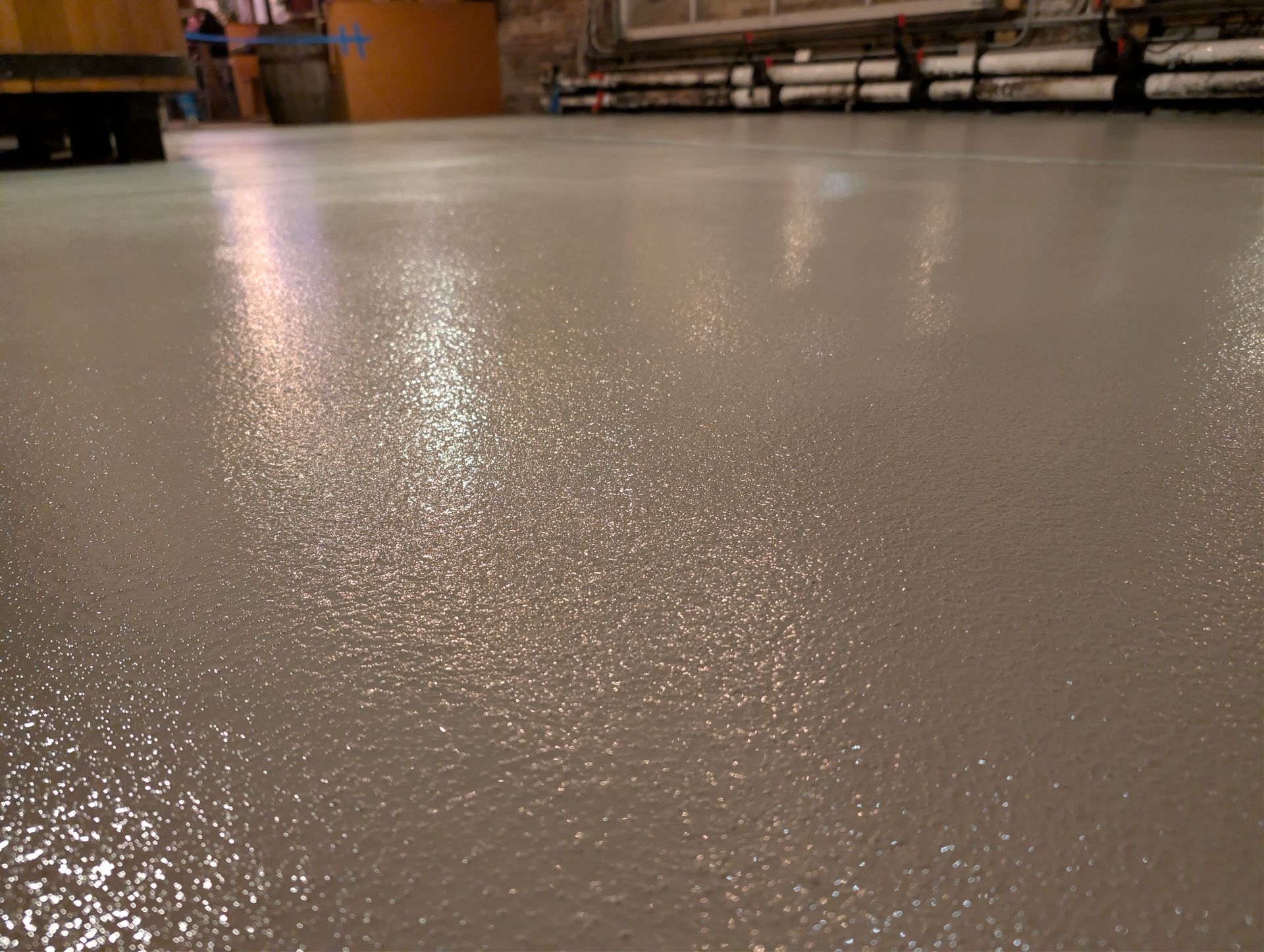 A concrete floor with a lot of small stones on it