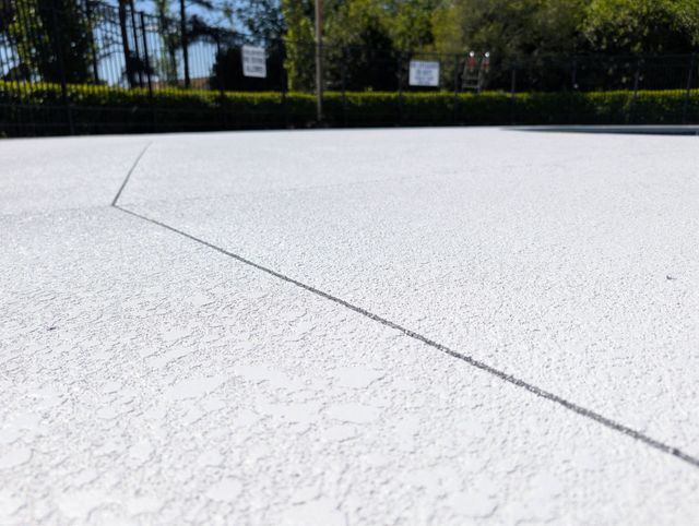 Knockdown pool deck resurfacing in light gray and slate in Roebuck, SC