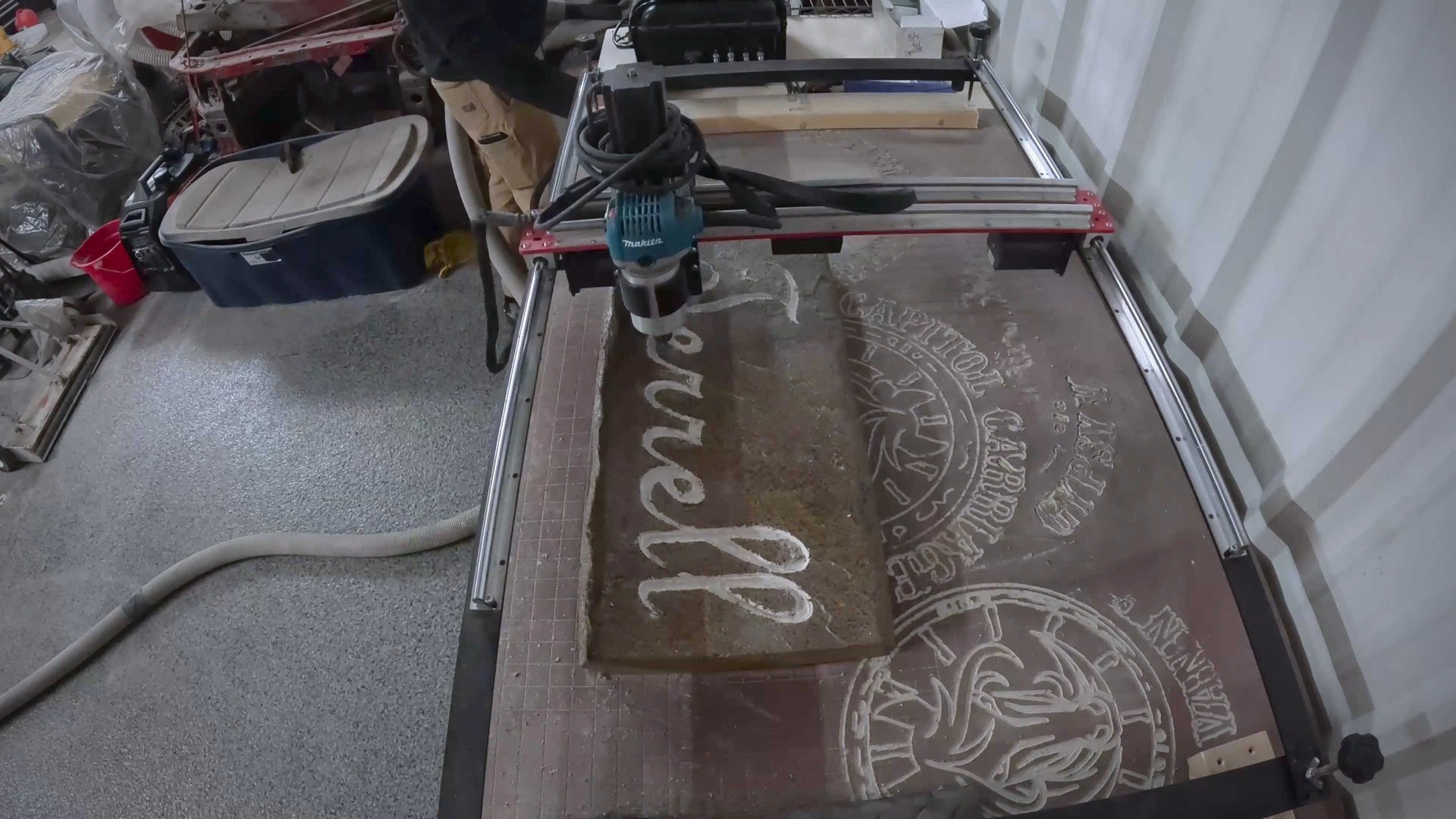 A man is using a machine to cut a piece of wood.