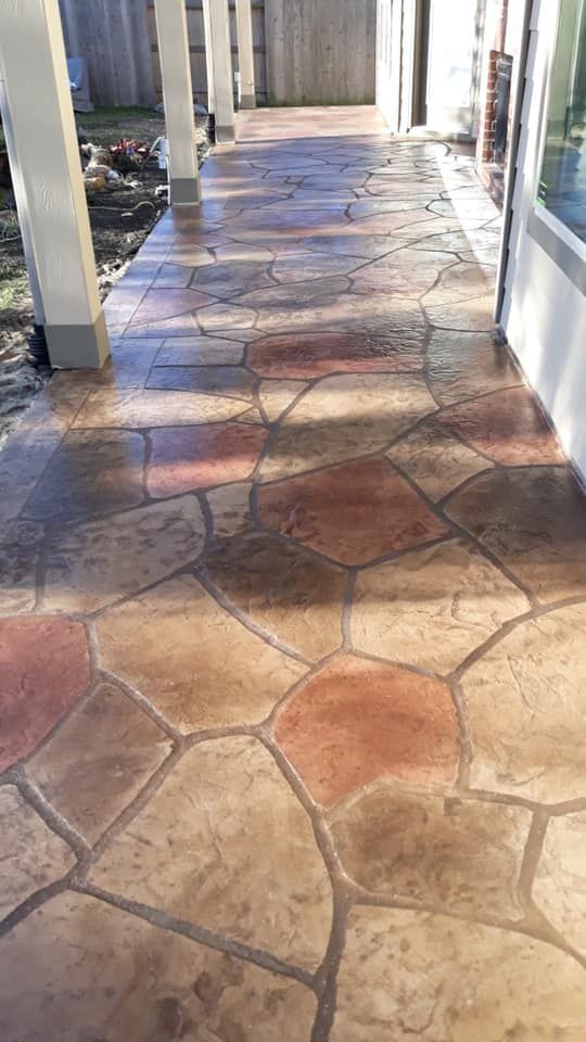 Stained and textured concrete patio in Spartanburg with a stone-look finish.