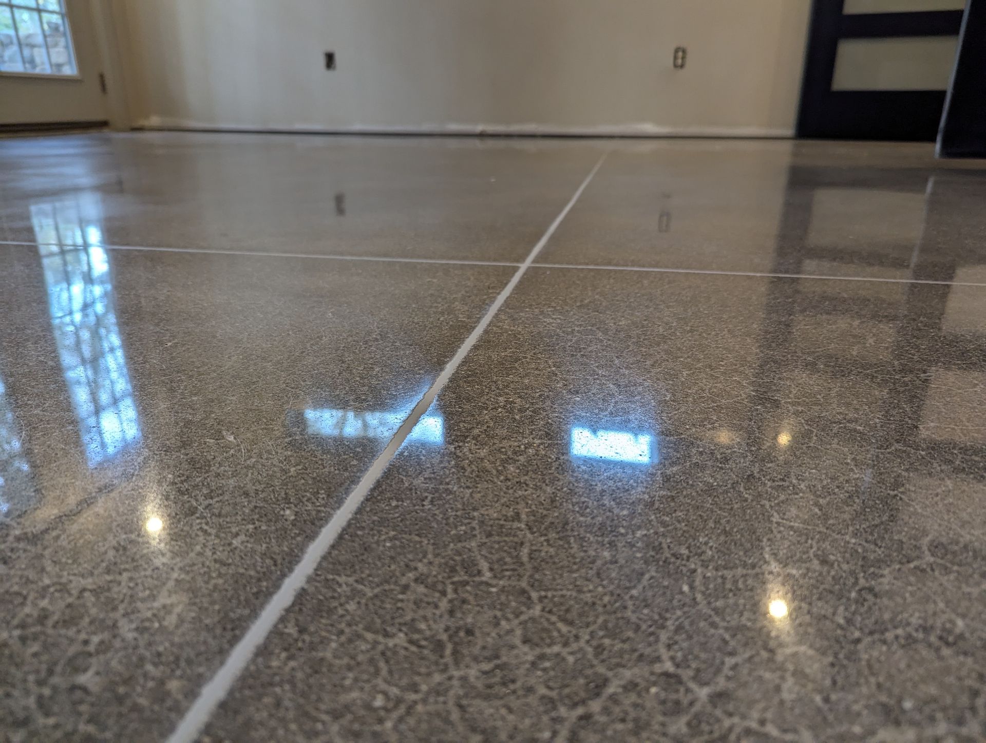 A close up of a shiny concrete floor in a room.