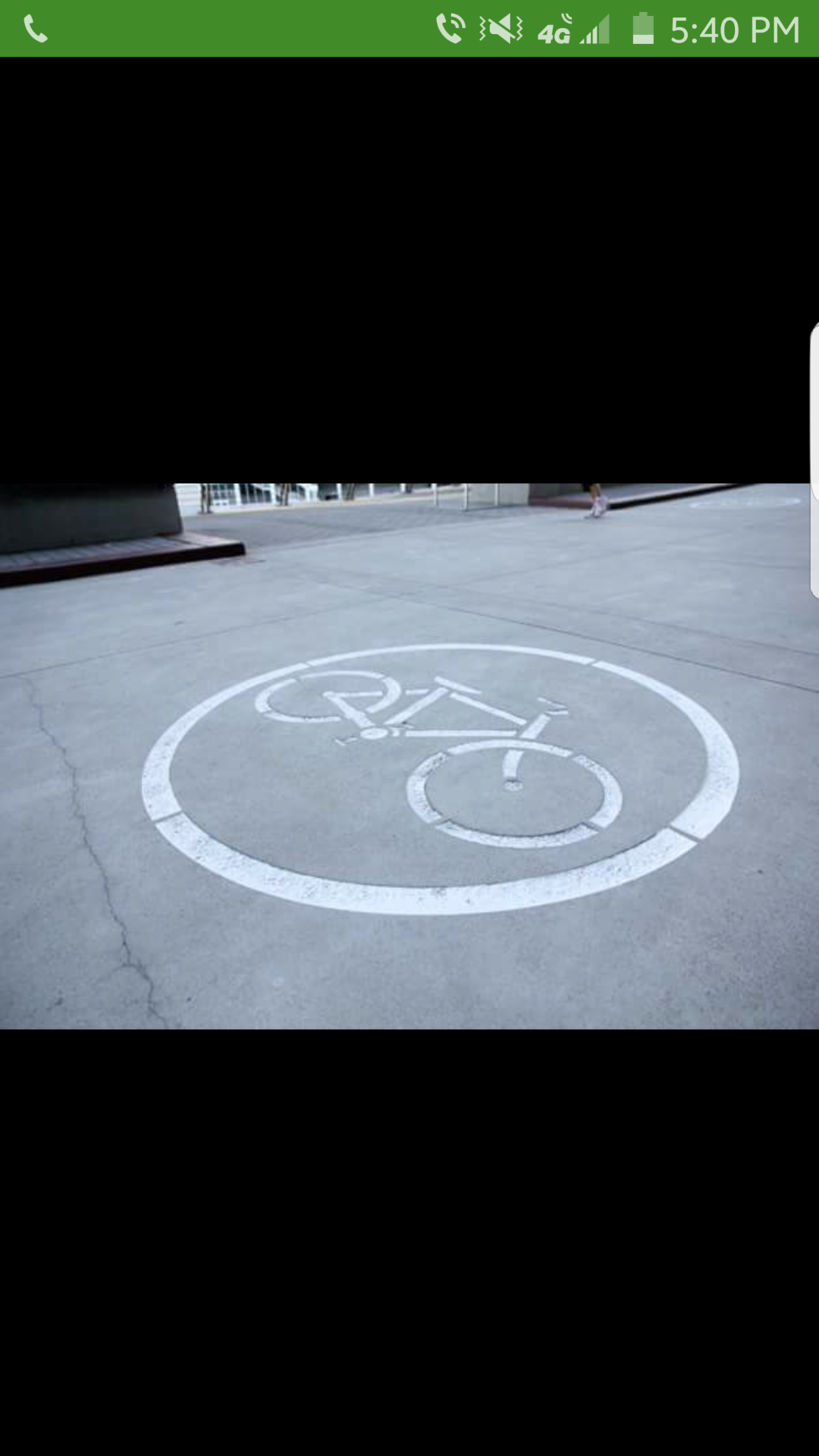 A bicycle is engraved in a circle on the concrete.