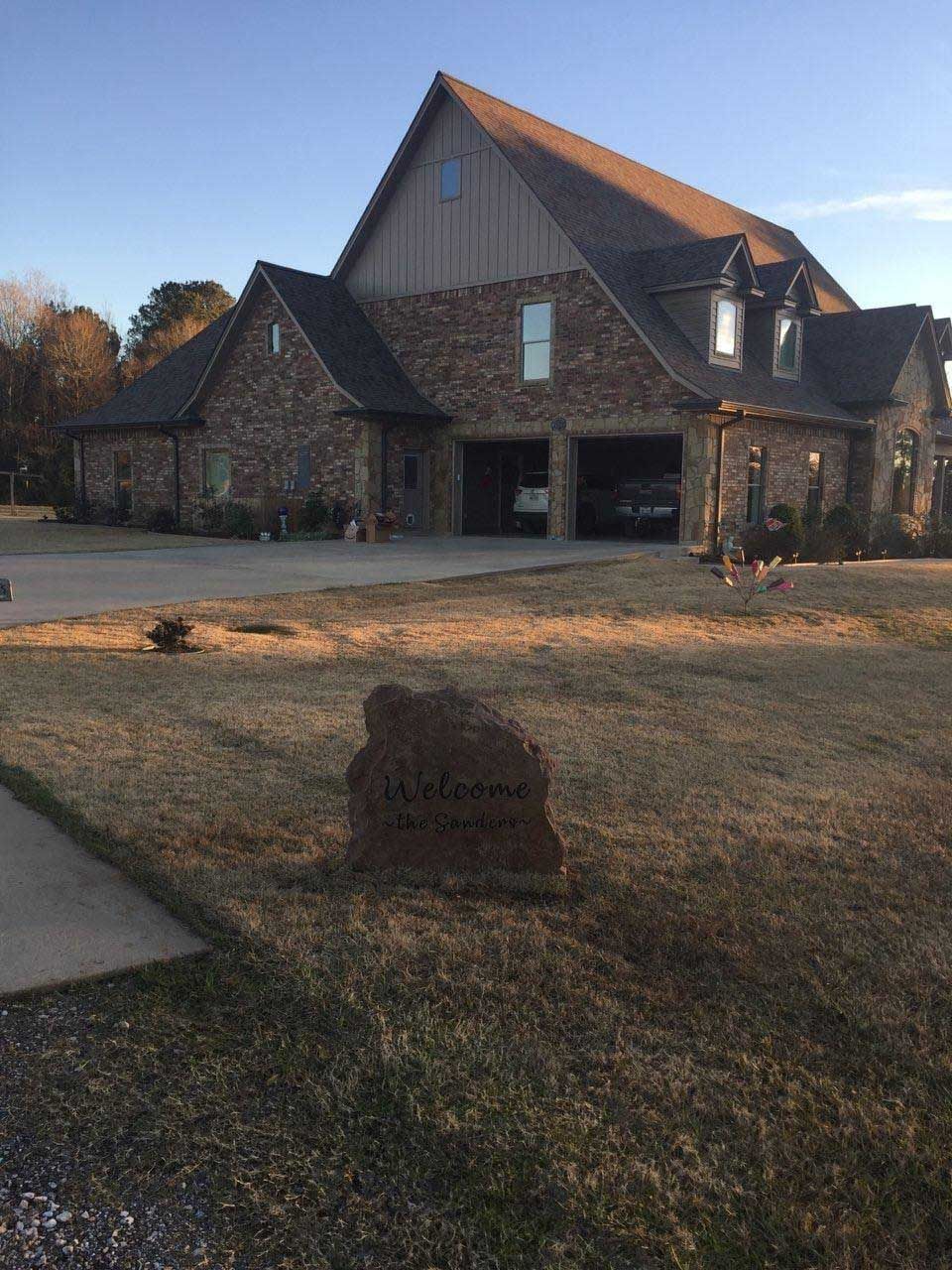 A large brick house with a garage and a driveway