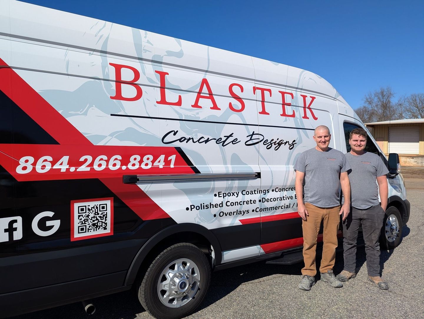 Two men are standing in front of a blastek van