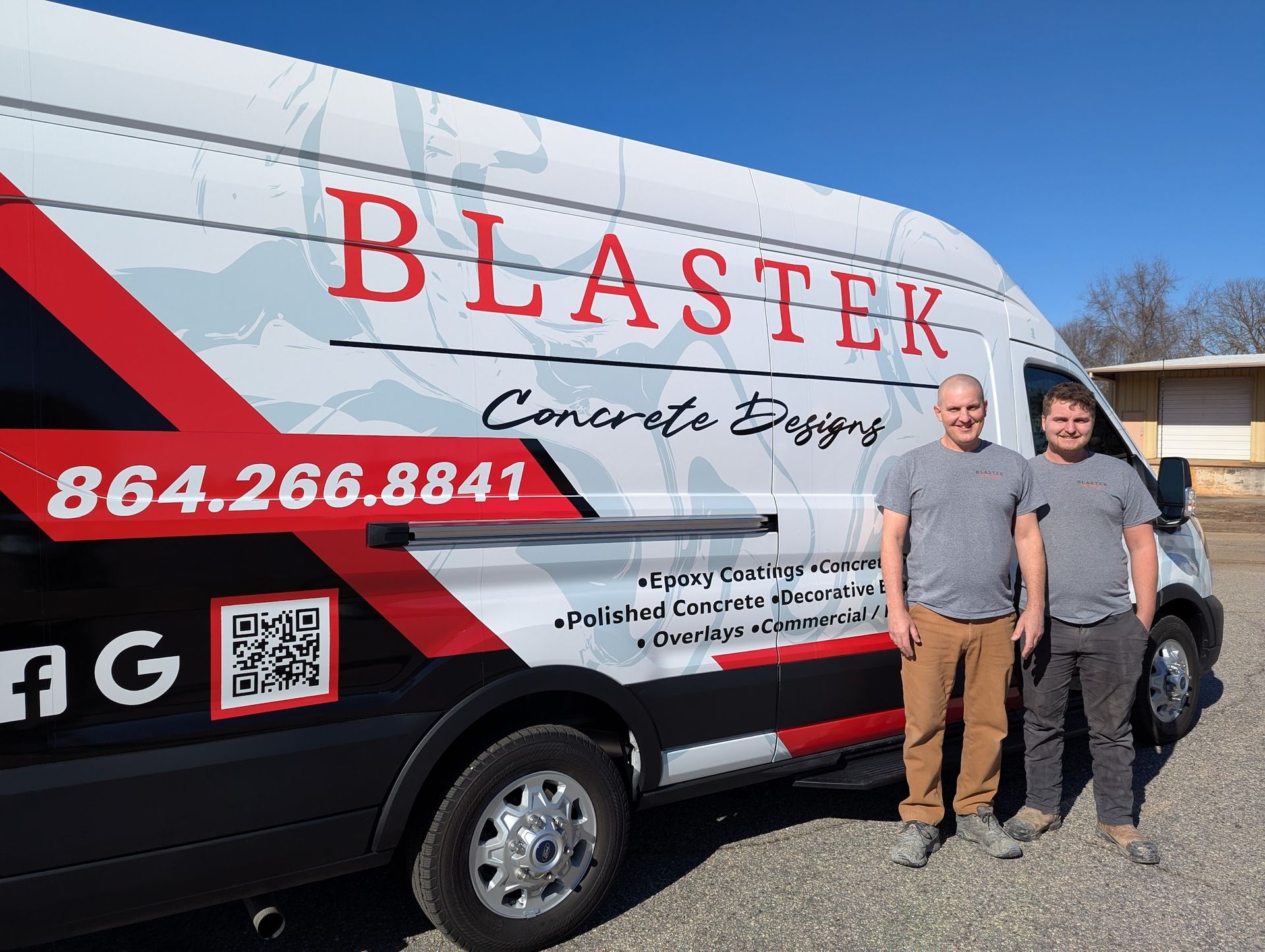Two men are standing in front of a blastek van