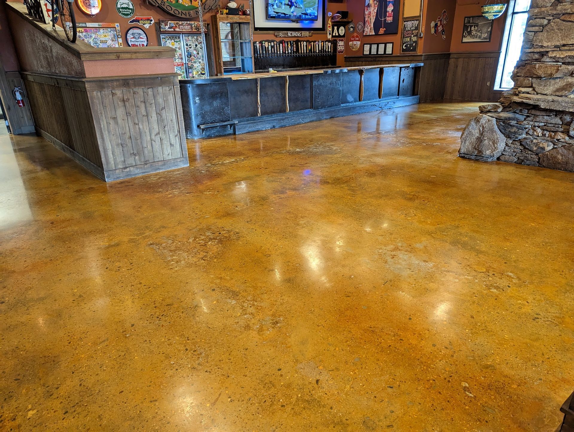 A concrete patio with a table and chairs in the background.