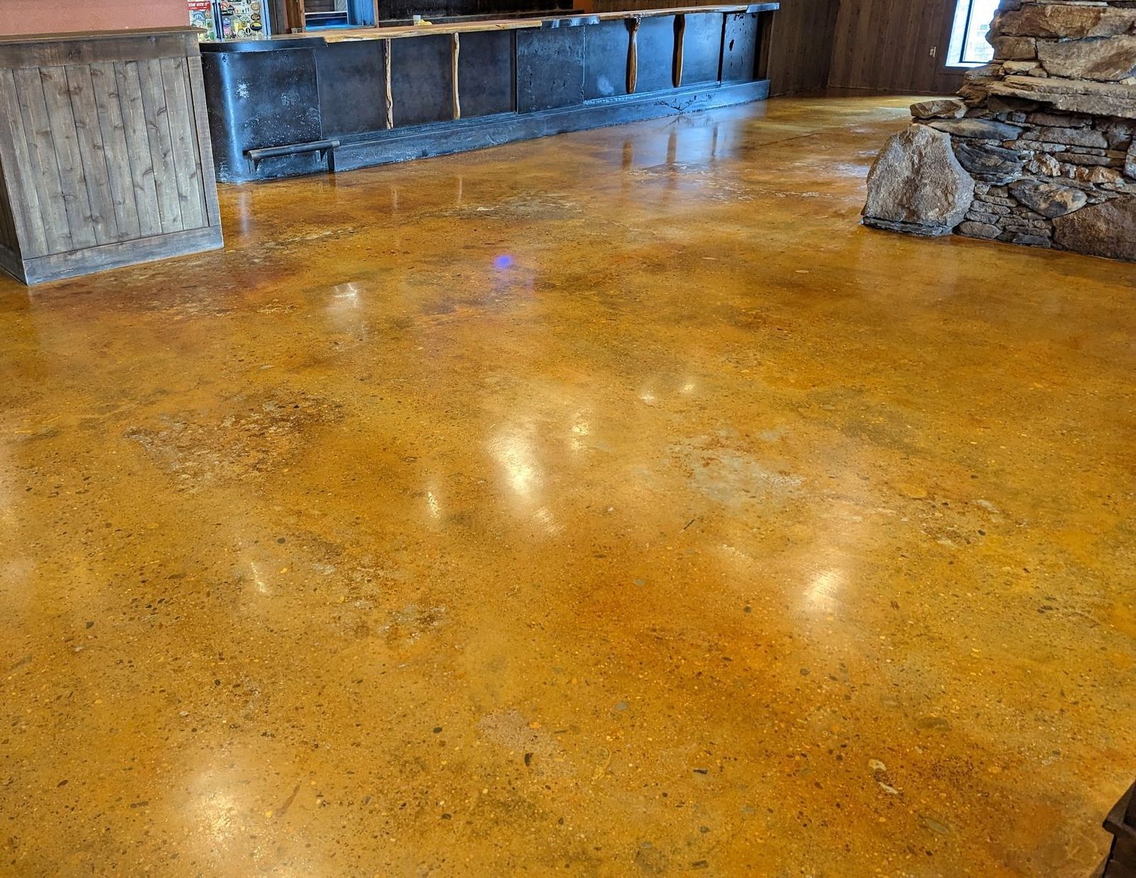A garage floor with a brick wall in the background.