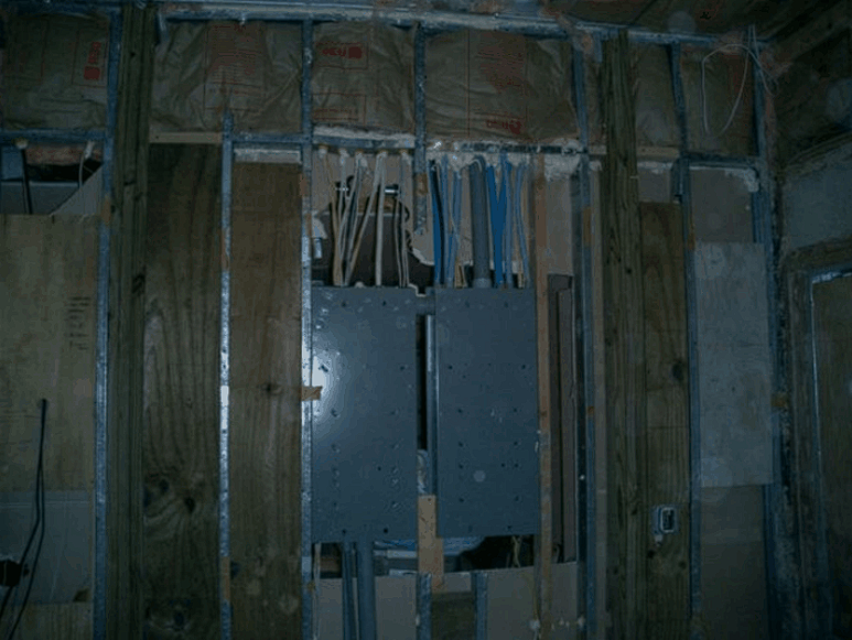A wall with electrical wires coming out of it