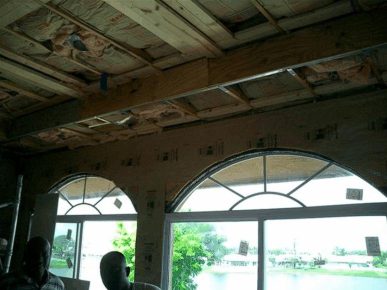 A room with arched windows and a wooden ceiling
