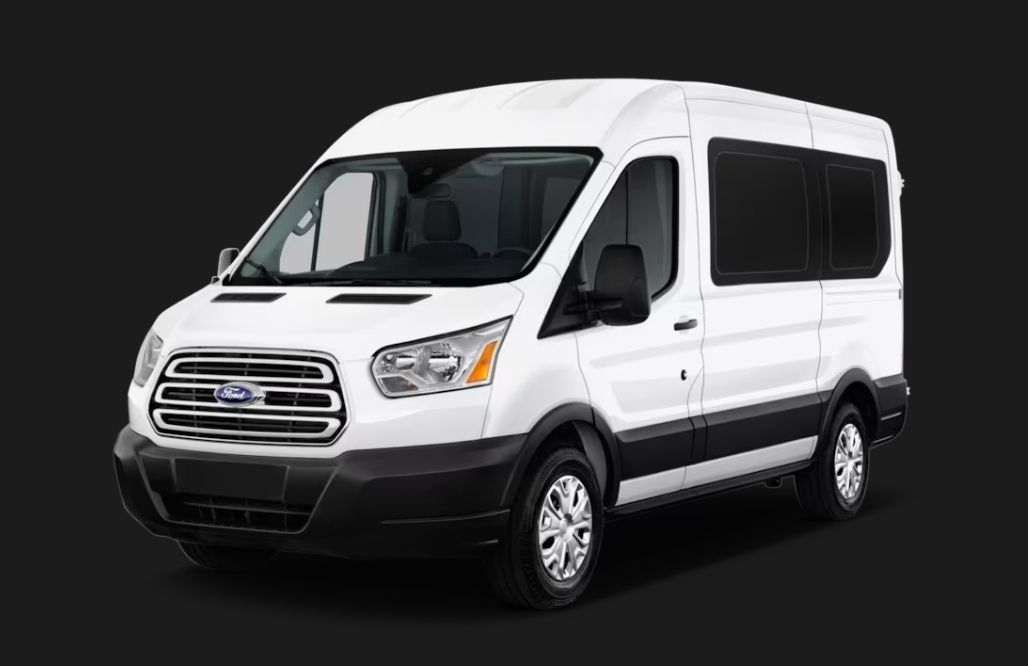 White Ford Transit passenger van on a dark background.