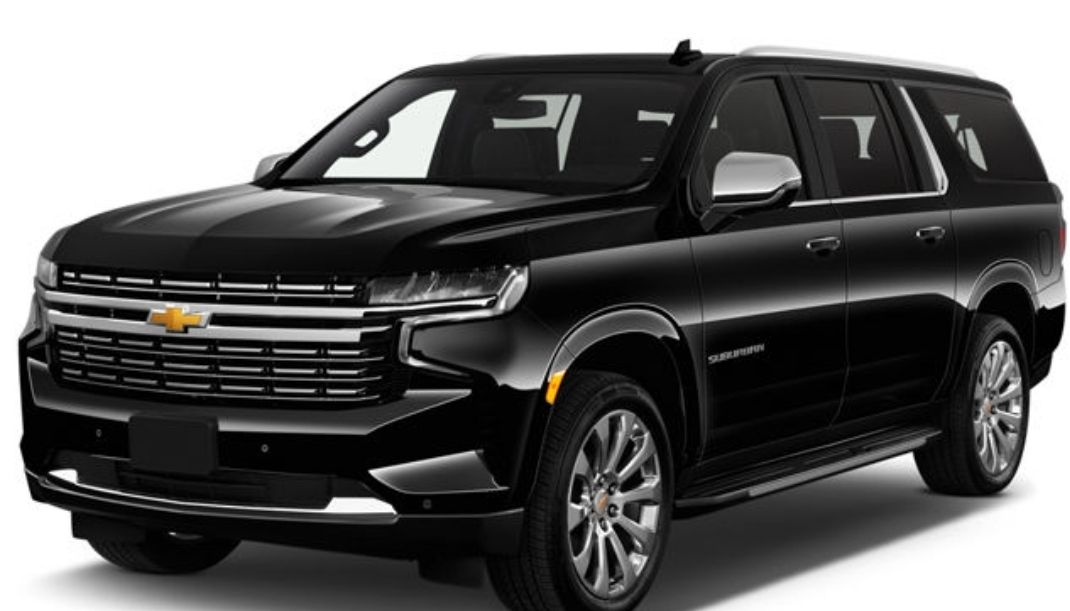 Black Chevrolet Suburban SUV parked, front view.