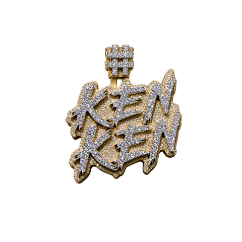 Gold and diamond-encrusted “KEN KEN” pendant with a crown on a white background