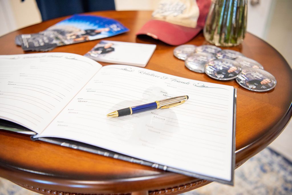 Guest book and memorial displayed for family and friends to share memories.