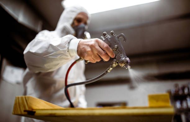 Carpenter Painting Wood with Spray Gun — Jacksonville, NC — C & S Paint Center Carpenter Painting Wood with Spray Gun — Jacksonville, NC — C & S Paint Center