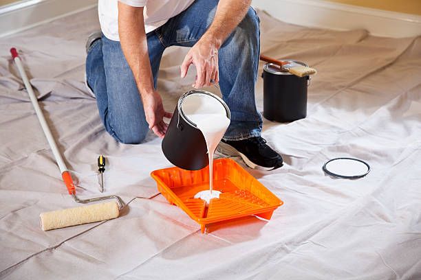 Pouring Paint Into Tray — Jacksonville, NC — C & S Paint Center Pouring Paint Into Tray — Jacksonville, NC — C & S Paint Center