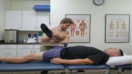 Hands massaging a bent knee, suggesting a sports injury or knee pain exercise