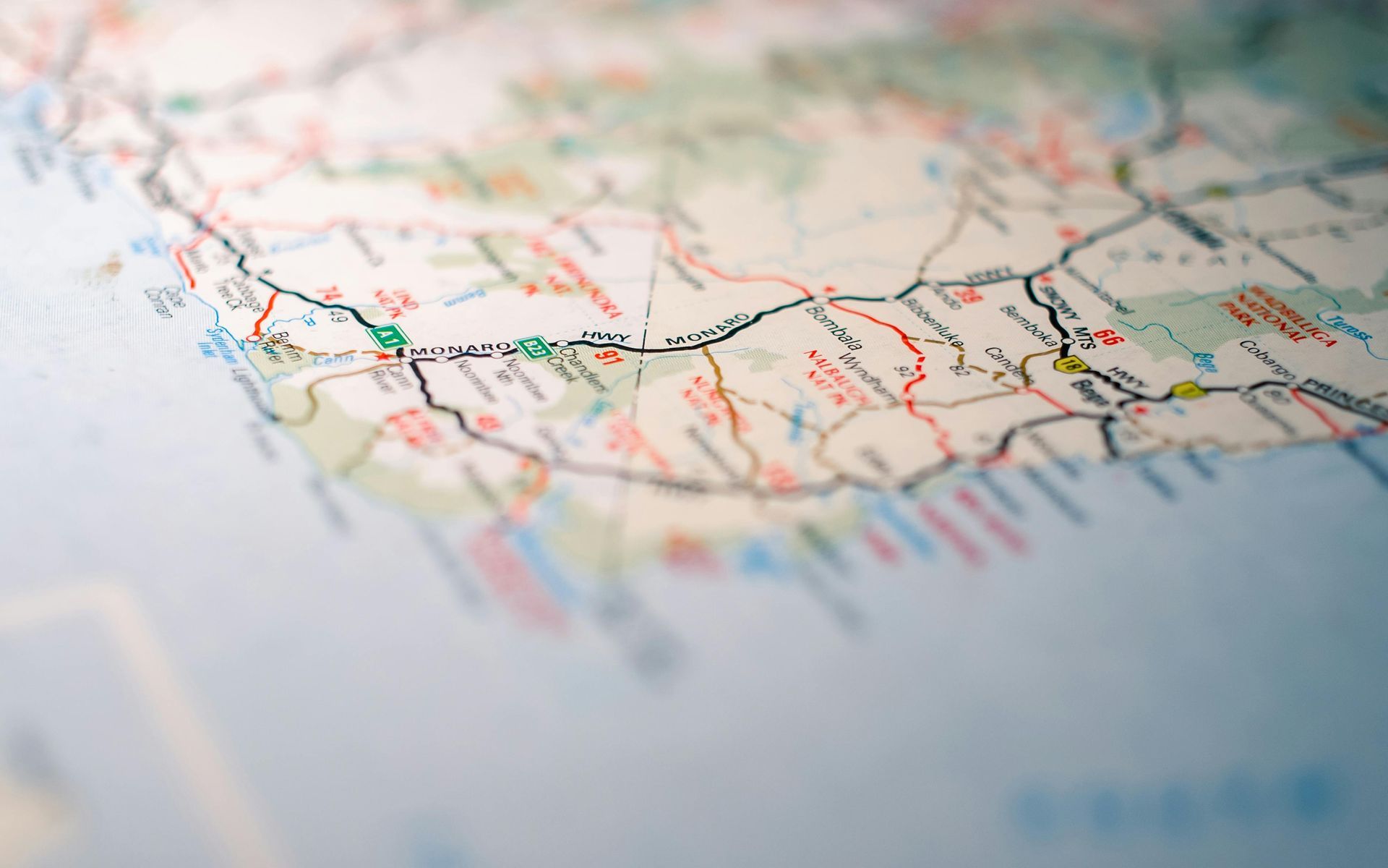 Blurred close-up of a road map with multicolored routes and place names