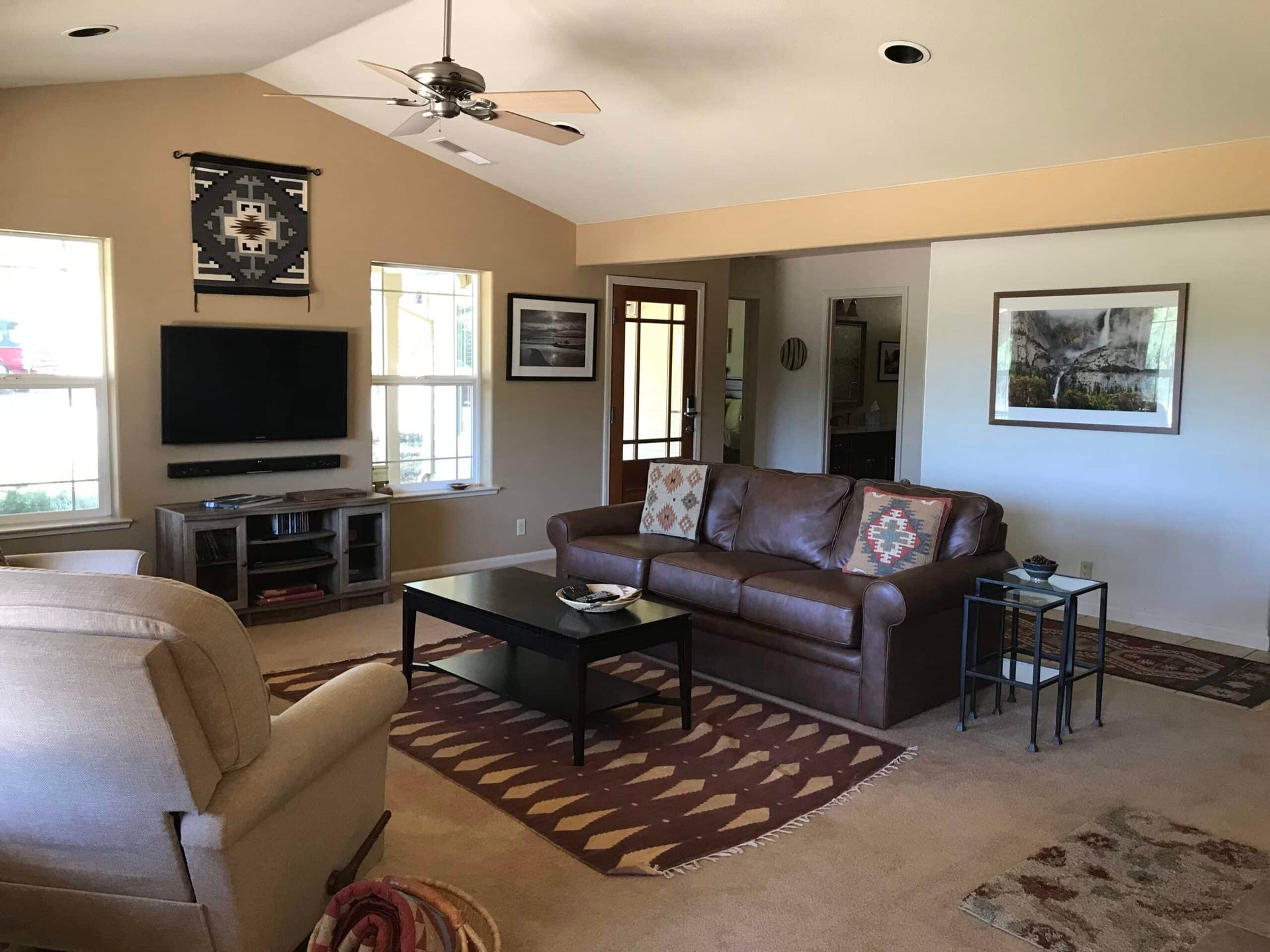 A living room with a brown couch and a flat screen tv
