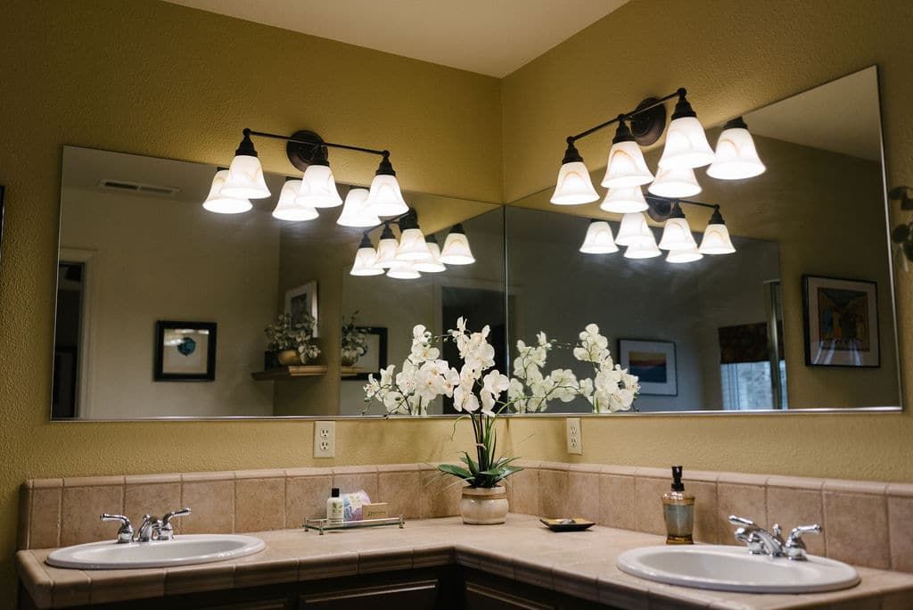 A bathroom with two sinks and a large mirror