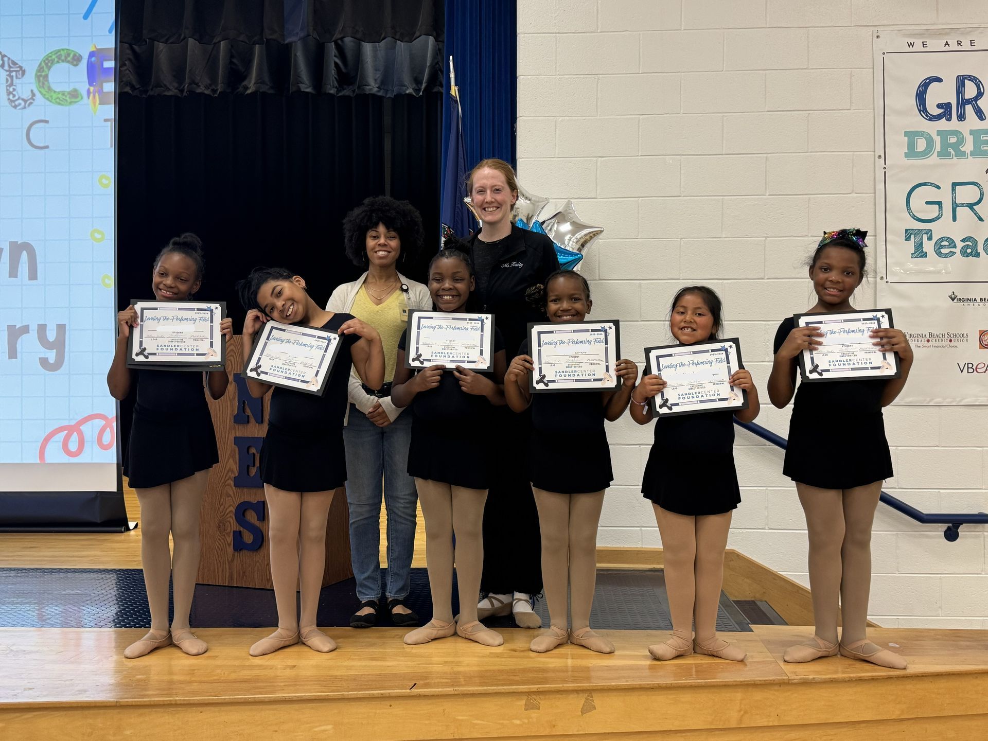 Young ballet dancers receiving awards.