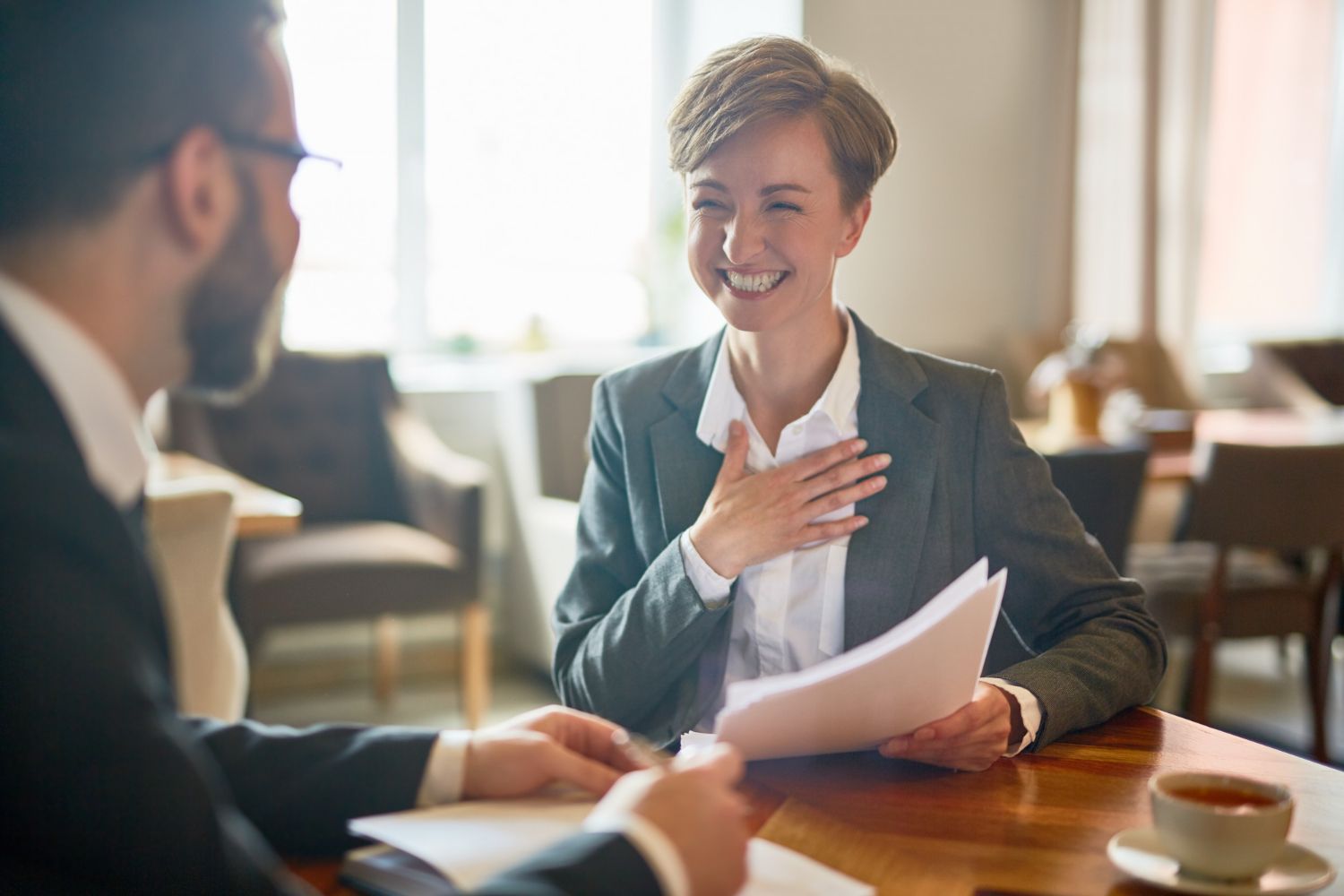 A family and a therapist give each other a high-five in a bright room.