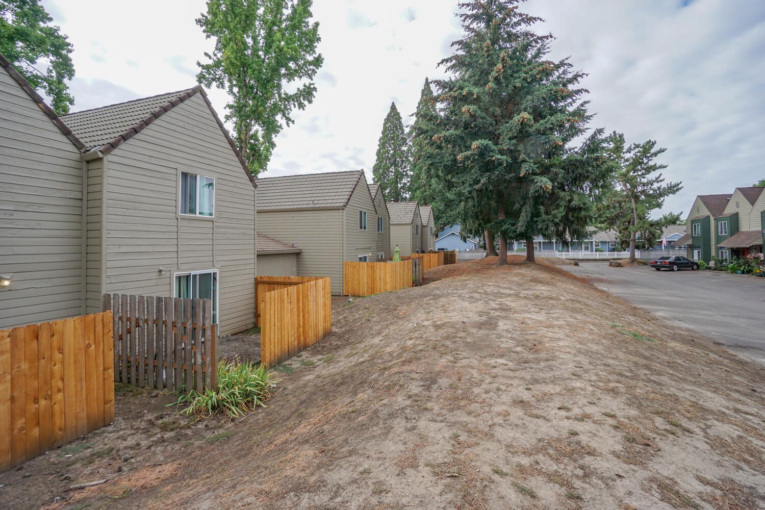 A row of houses with a wooden fence in front of them.