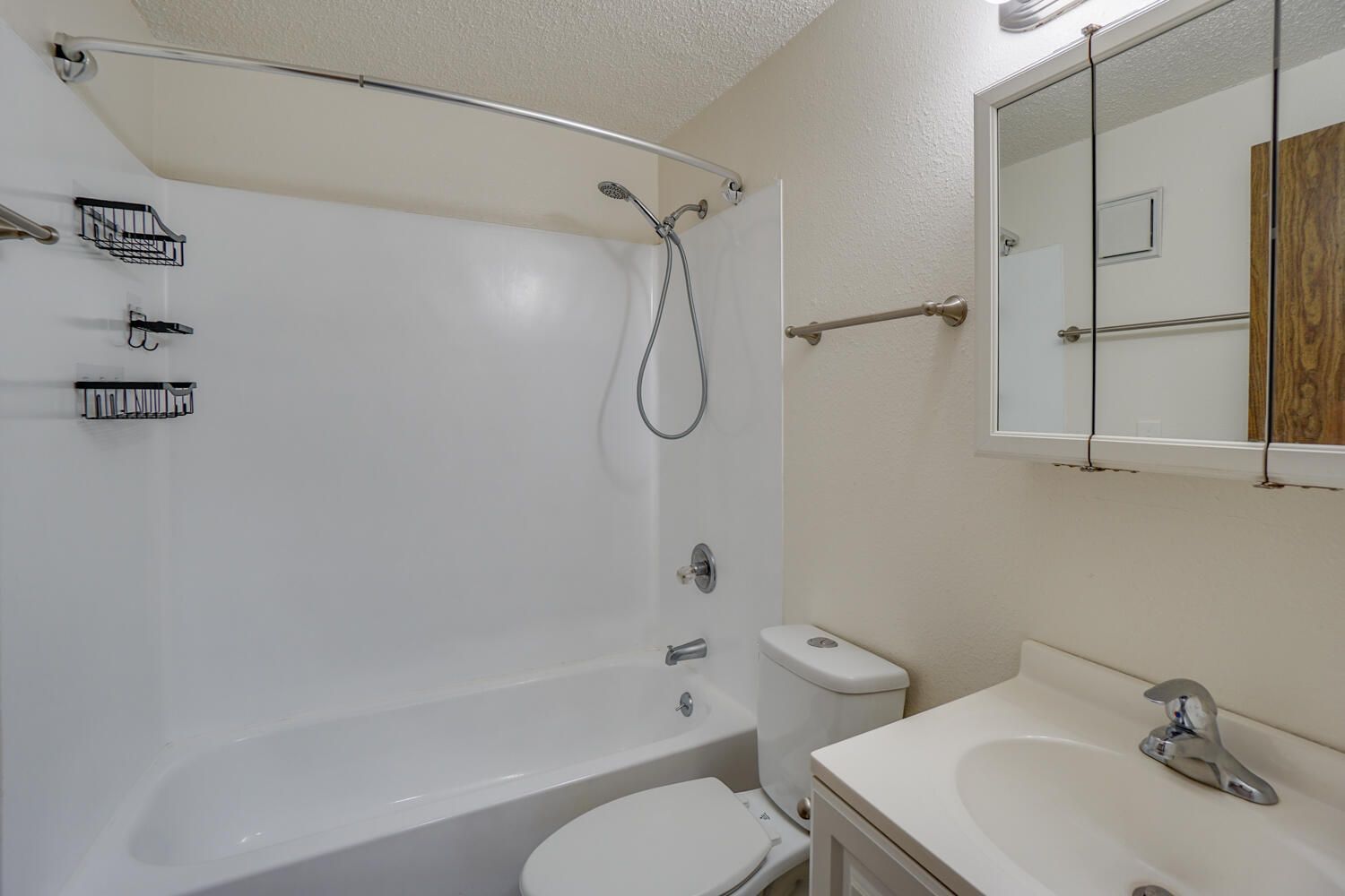 A bathroom with a toilet , sink and bathtub