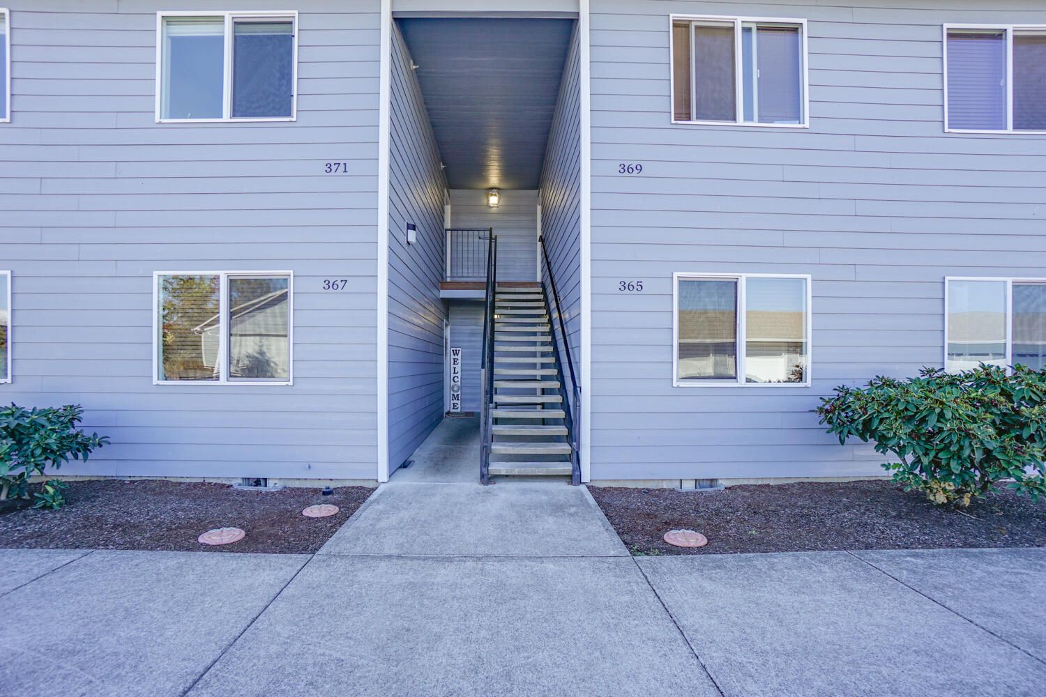 A building with stairs leading up to the second floor