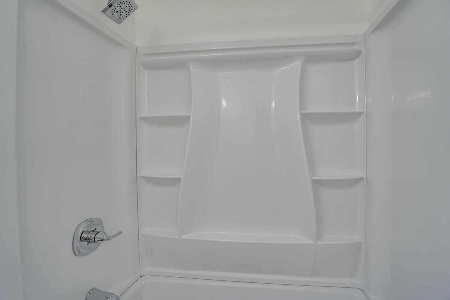 A bathroom with a shower stall and a bathtub.