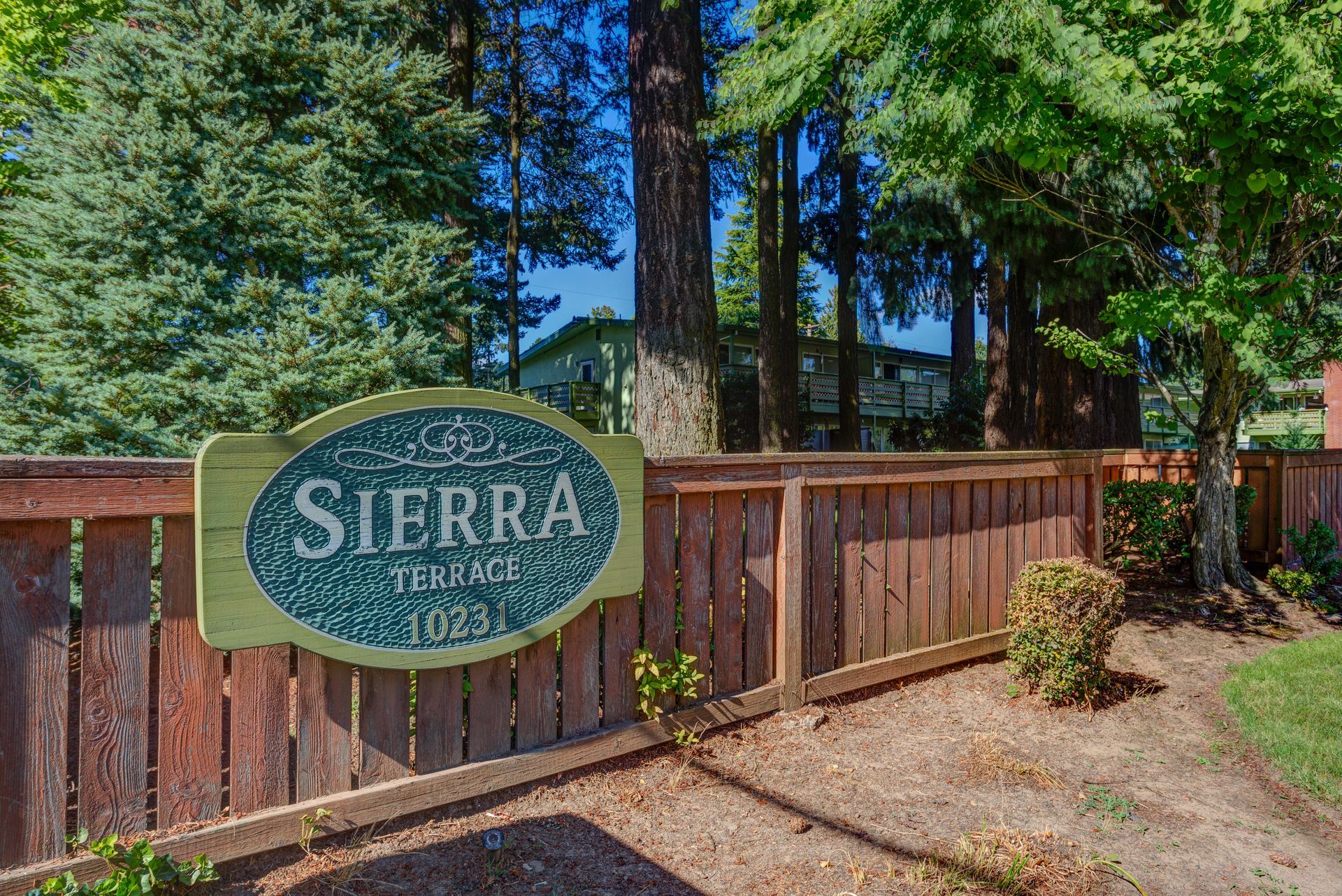 A wooden fence with a sign that says sierra terrace on it.