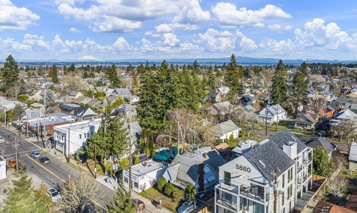 An aerial view of a residential area with lots of houses and trees.