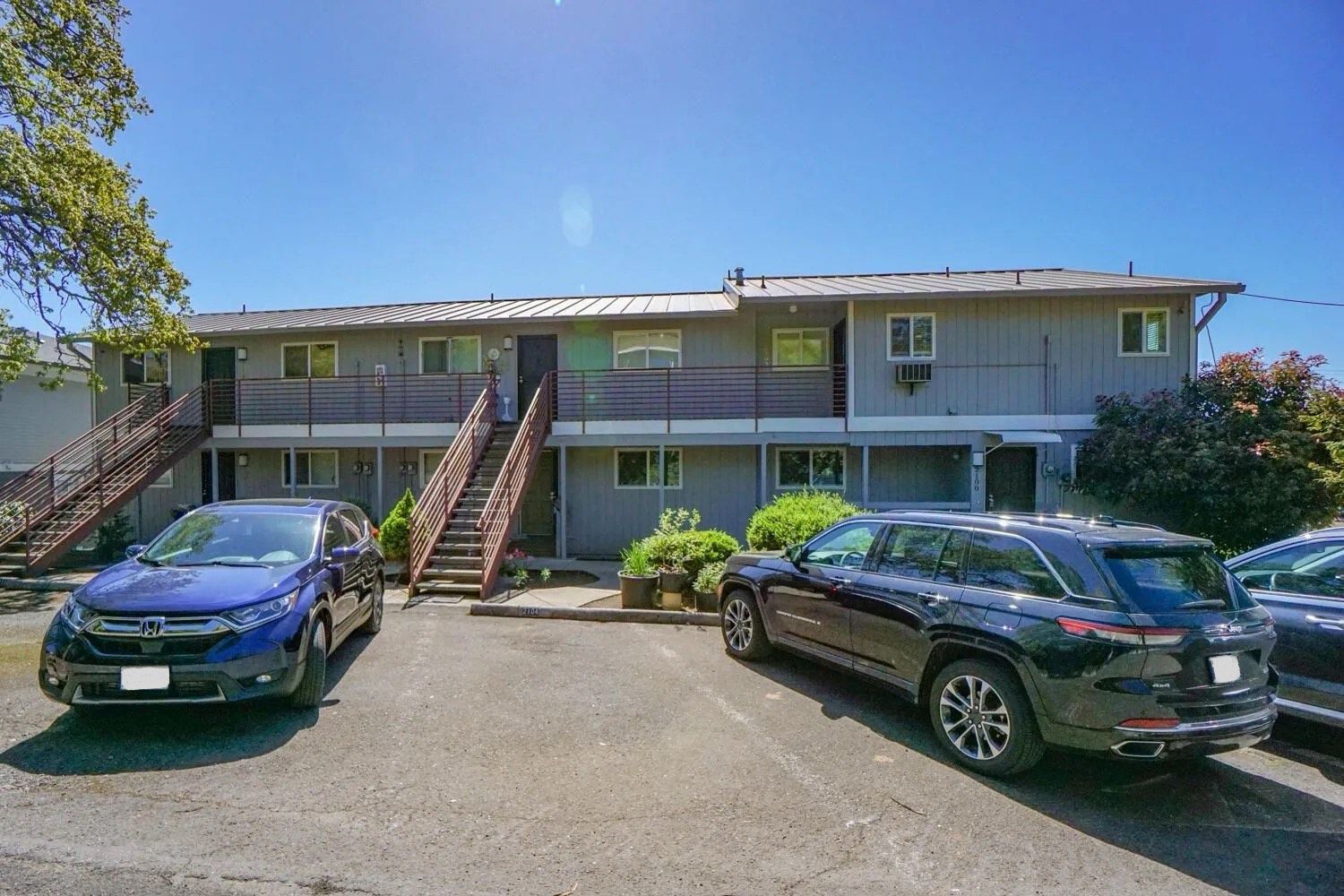 A couple of cars are parked in front of a building.