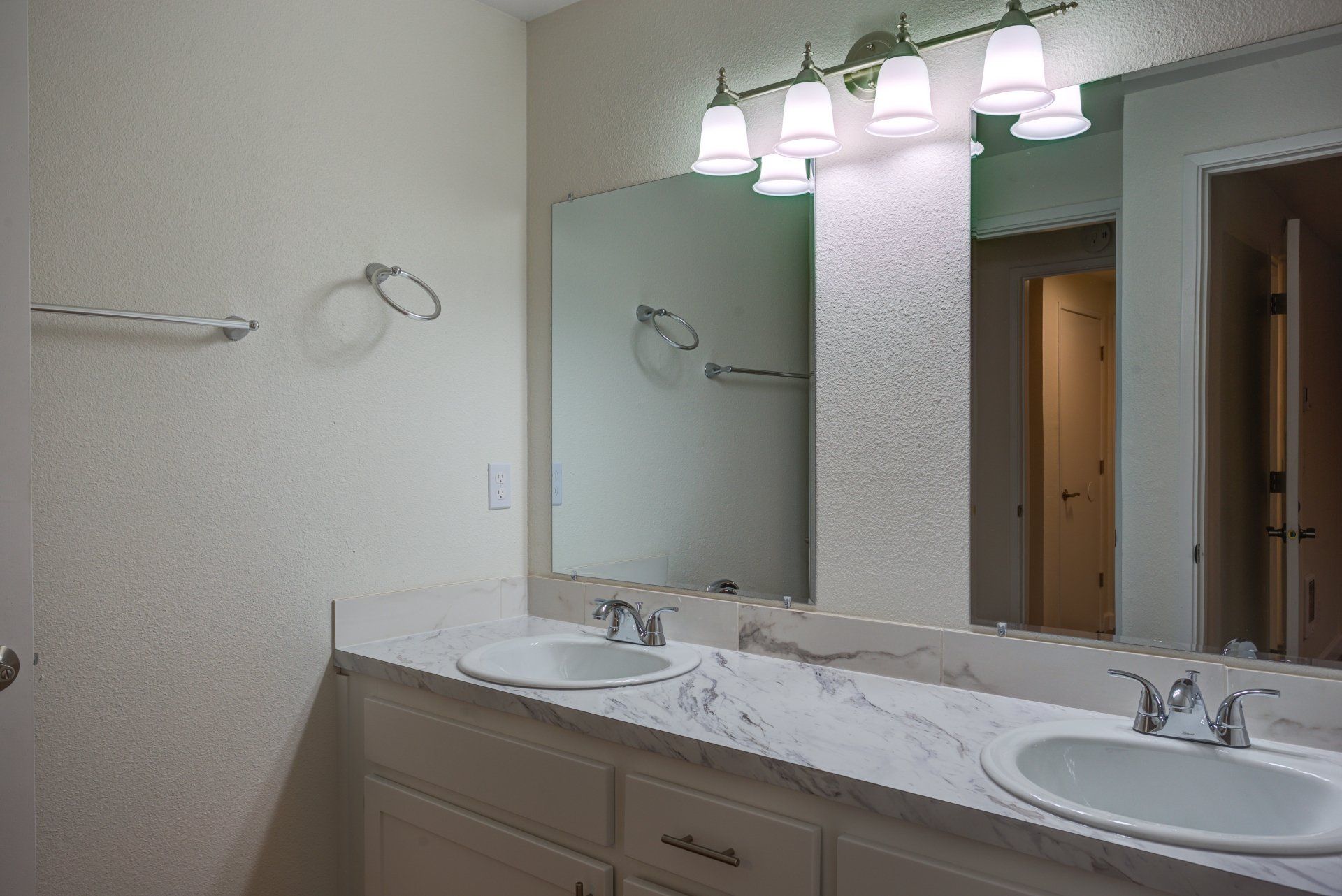 A bathroom with two sinks and a large mirror