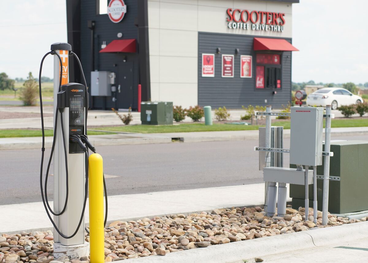 EV charging station with cables beside a roadside Scooters Coffee shop