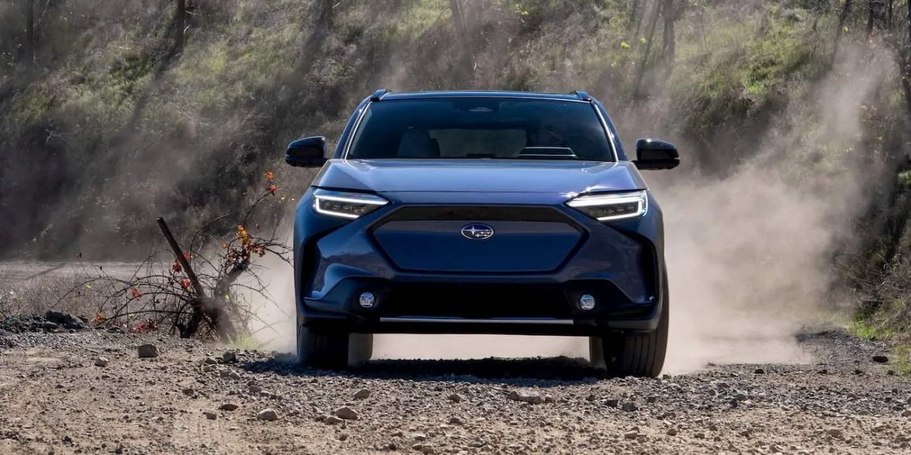 Blue Ford SUV driving on a dusty dirt road