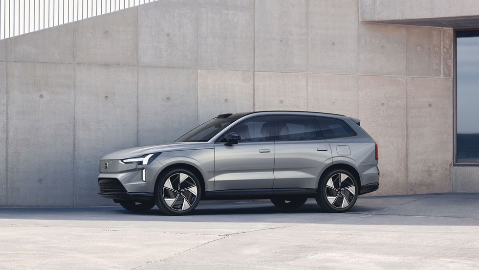 Silver SUV parked beside a concrete wall in a modern outdoor setting