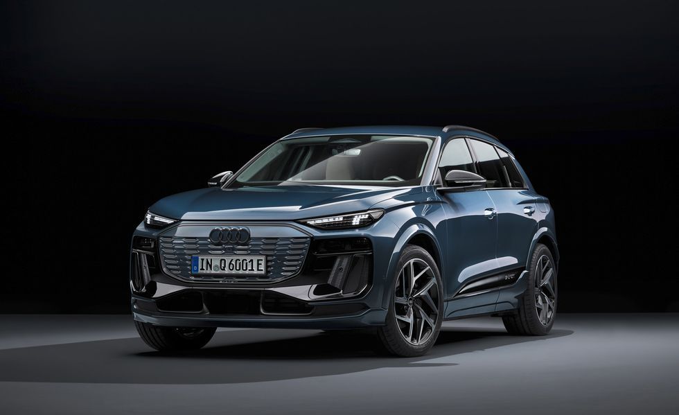 Dark blue SUV on a studio backdrop, angled front view with black wheels and LED headlights