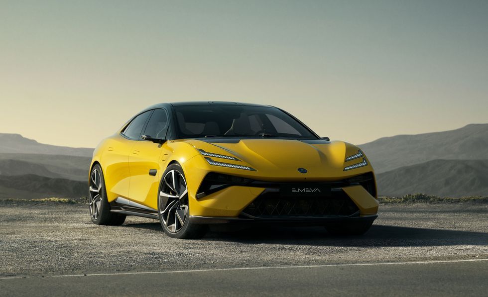 Yellow sports car parked on a desert road with mountains in the background