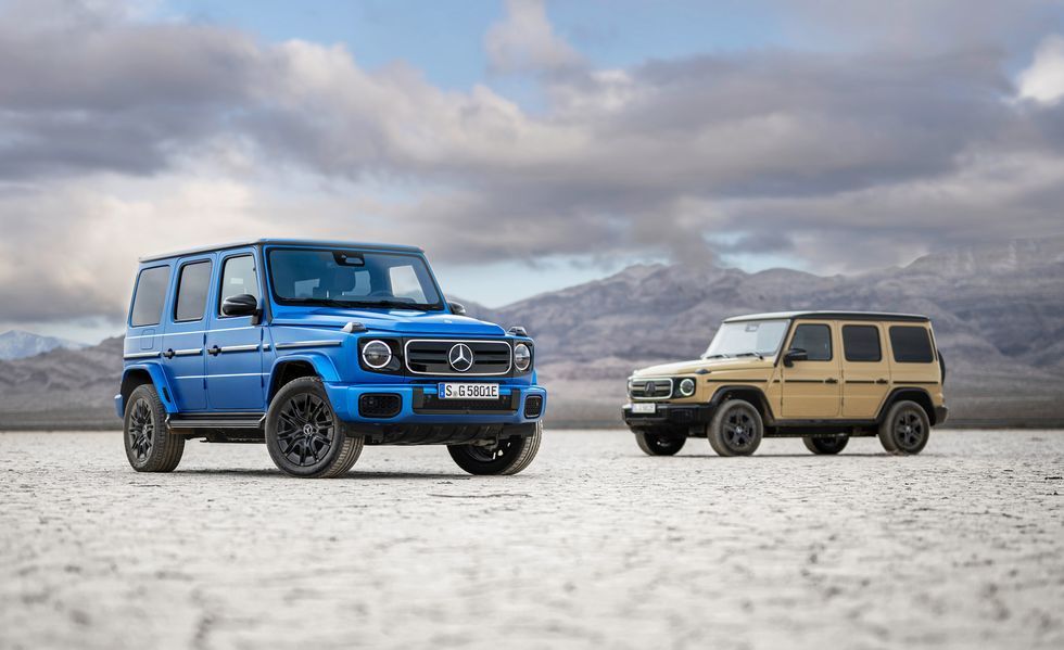 Blue SUV and beige SUV parked on a white salt flat with mountains and cloudy sky in the background