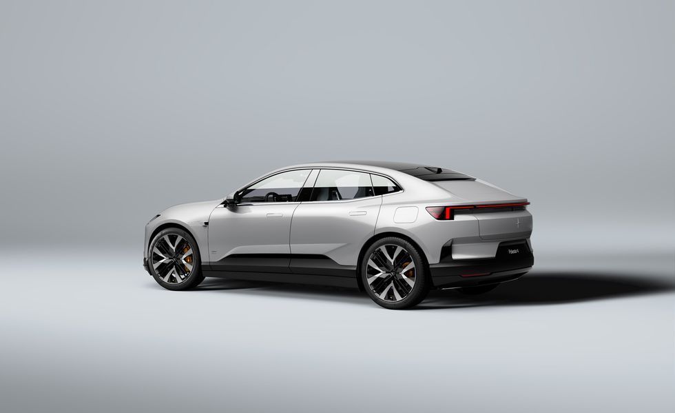 Silver SUV in side view on a plain gray studio background