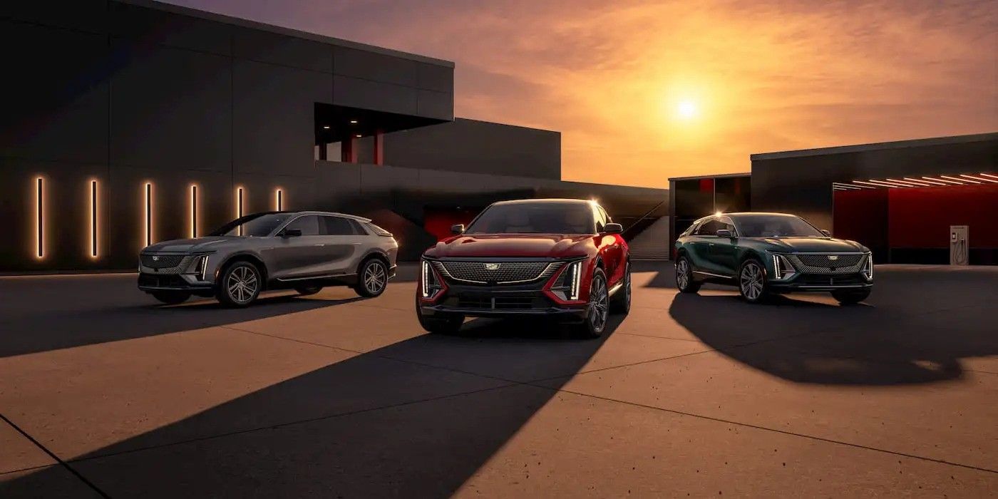 Three luxury cars parked at sunset outside a modern building