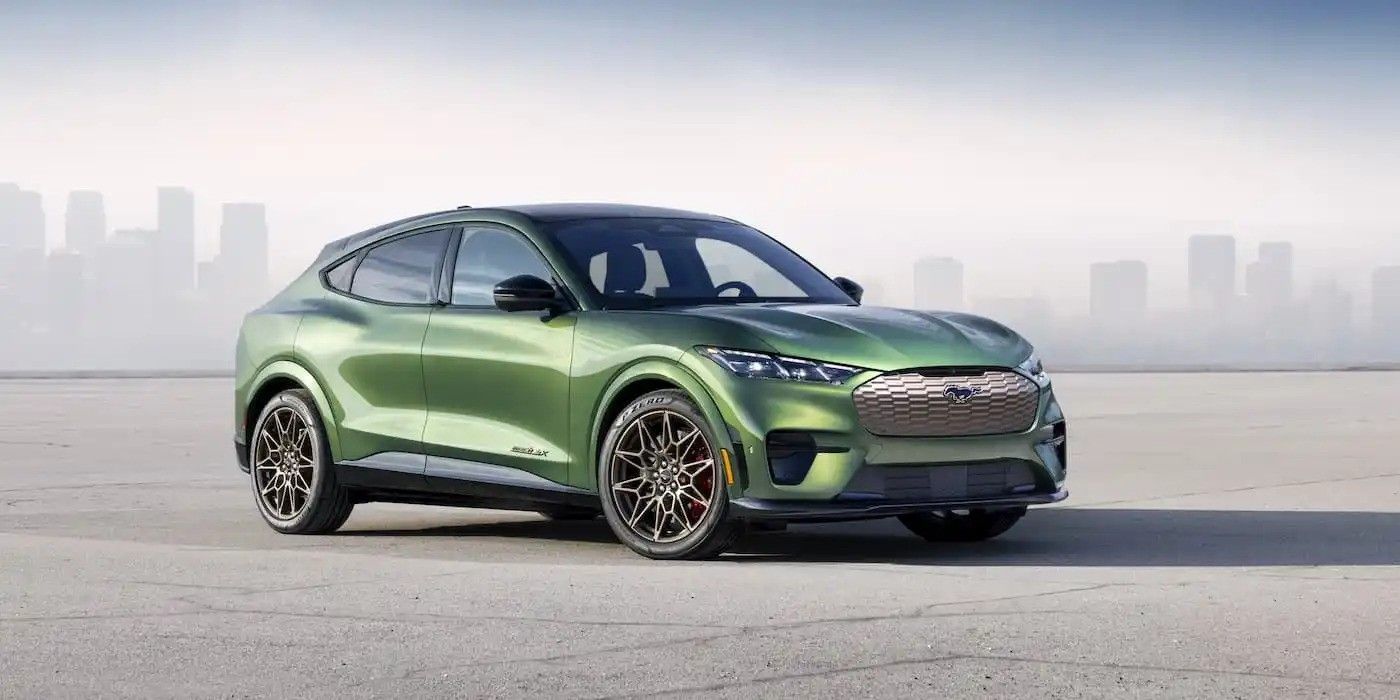 Green SUV parked on a flat surface with a hazy city skyline in the background