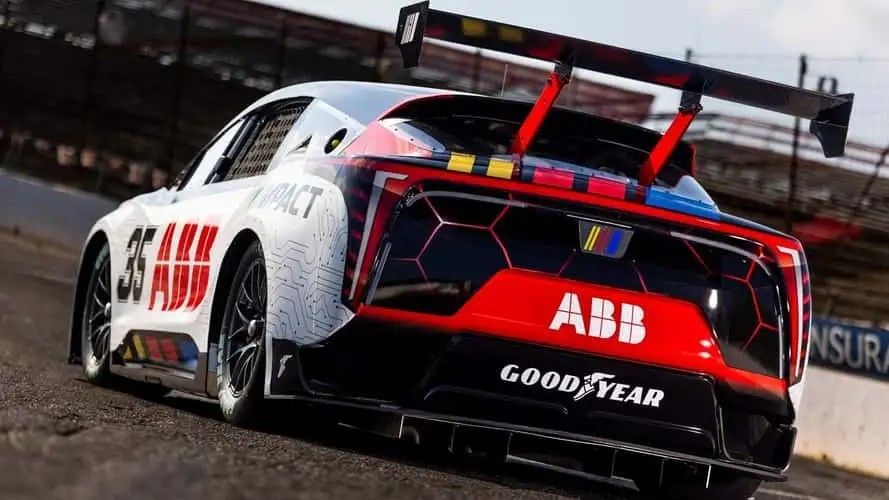 ABB Goodyear race car drifting on a wet track, rear view with red accents and spoiler