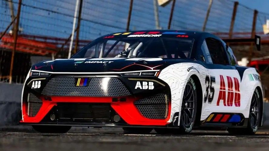 Black-and-white ABB race car #35 on a track with red accents, viewed from the front-left.