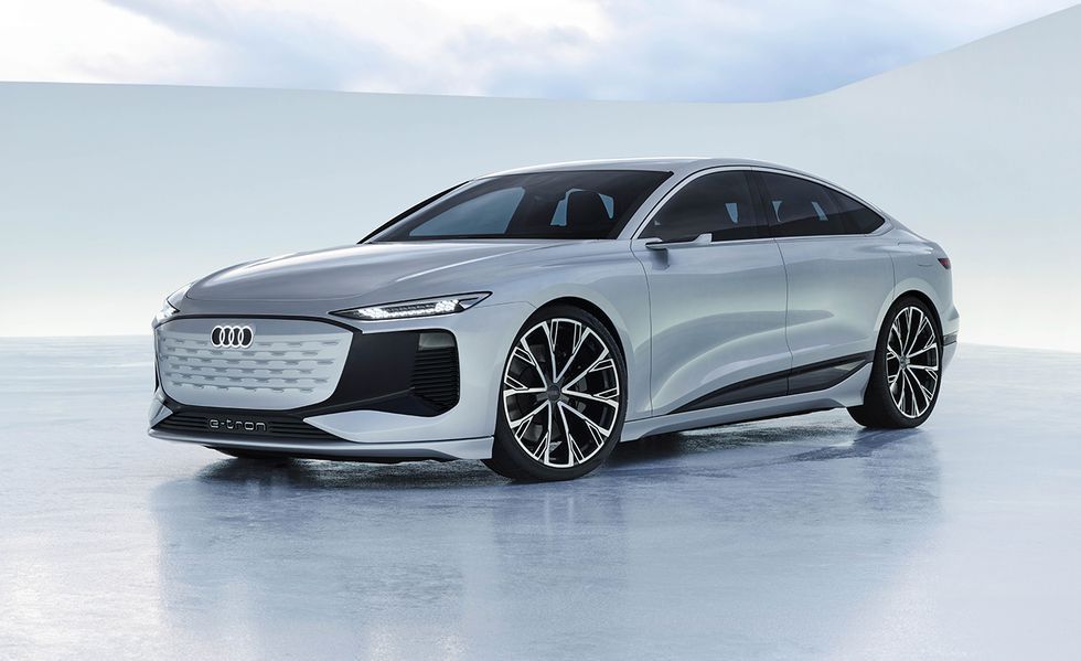 Silver sports sedan on a snowy surface with a minimalist white background, front three-quarter view.