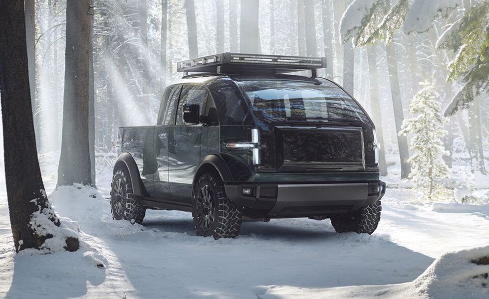 Dark electric off-road truck driving through a snowy forest road