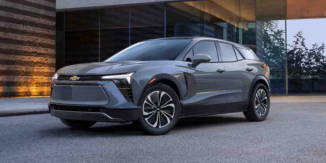 Dark gray electric SUV parked outside a modern building at dusk