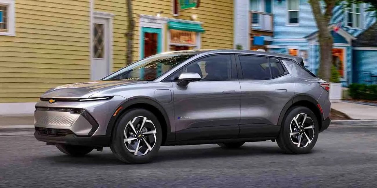 Gray SUV parked on a city street in front of colorful houses
